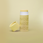 Load image into Gallery viewer, Yellow Noz stick sunscreen with the cap off modeled in a yellow background
