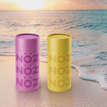 Load image into Gallery viewer, Purple and Yellow Noz sunscreen projected on a beach
